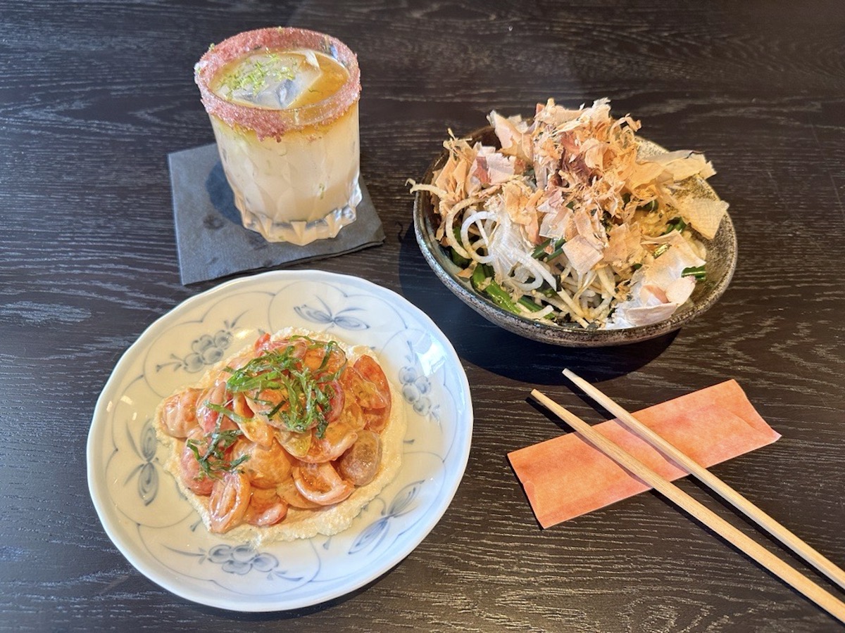 salt-rimmed cocktail with tomato and fern salads