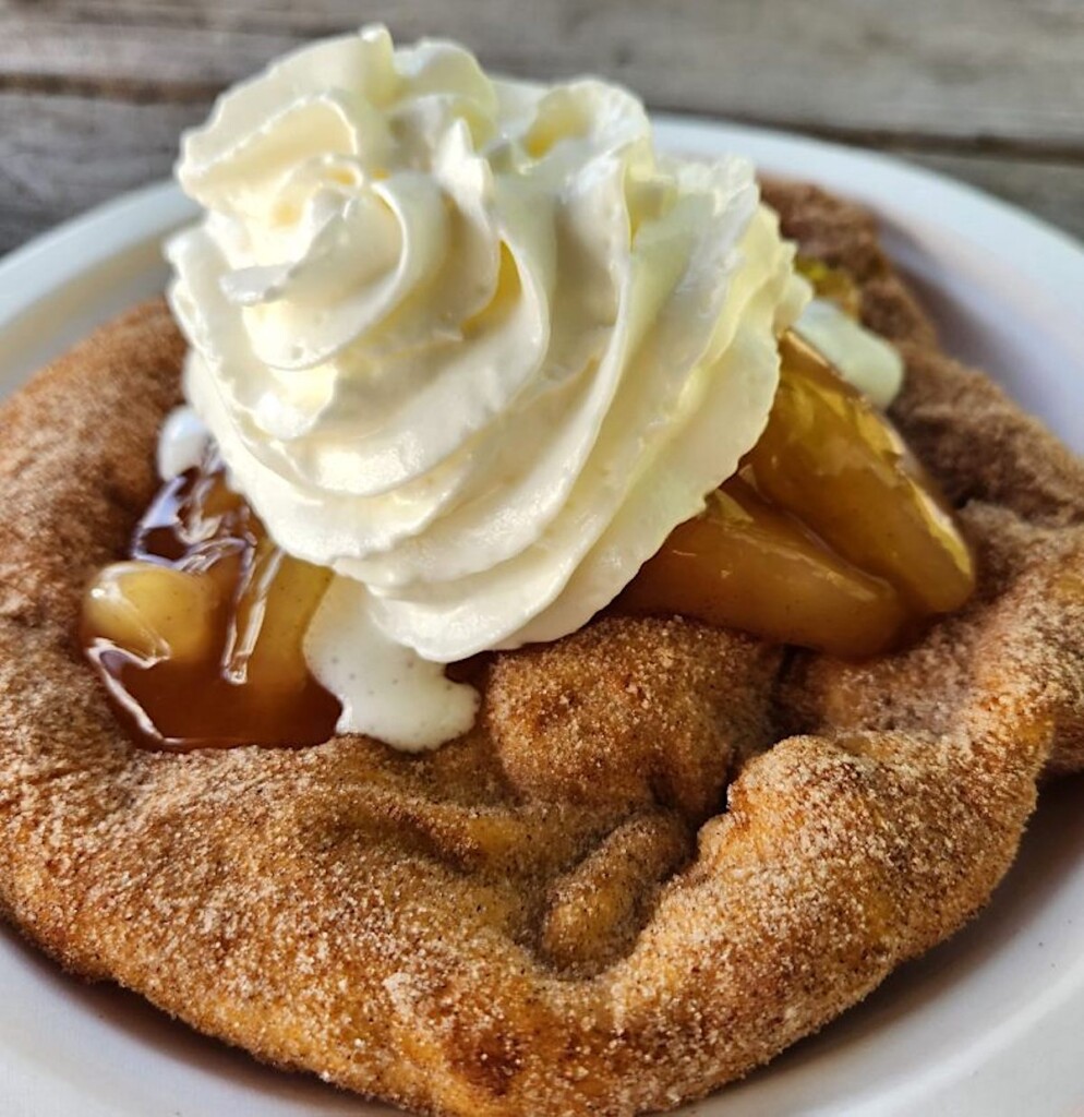 native american fry bread topped with apples and whipped cream