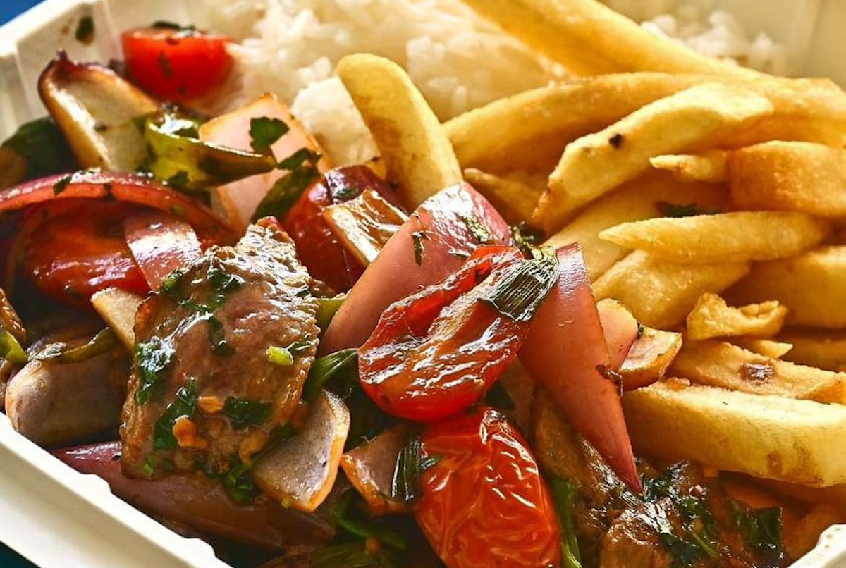 takeout box overflowing with lomo saltado