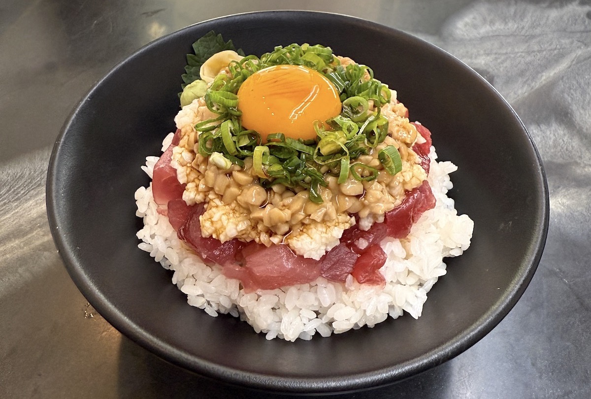 black bowl holds rice with ahi poke and toppings