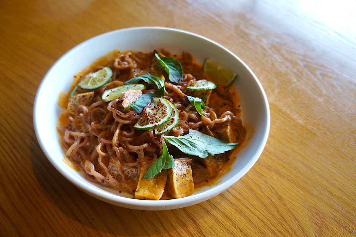 Laksa noodles and toppings in white bowl