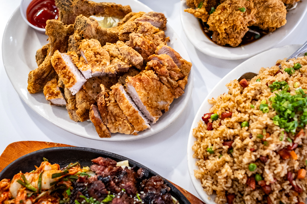 large platters hold fried pork chops, fried rice and kalbi
